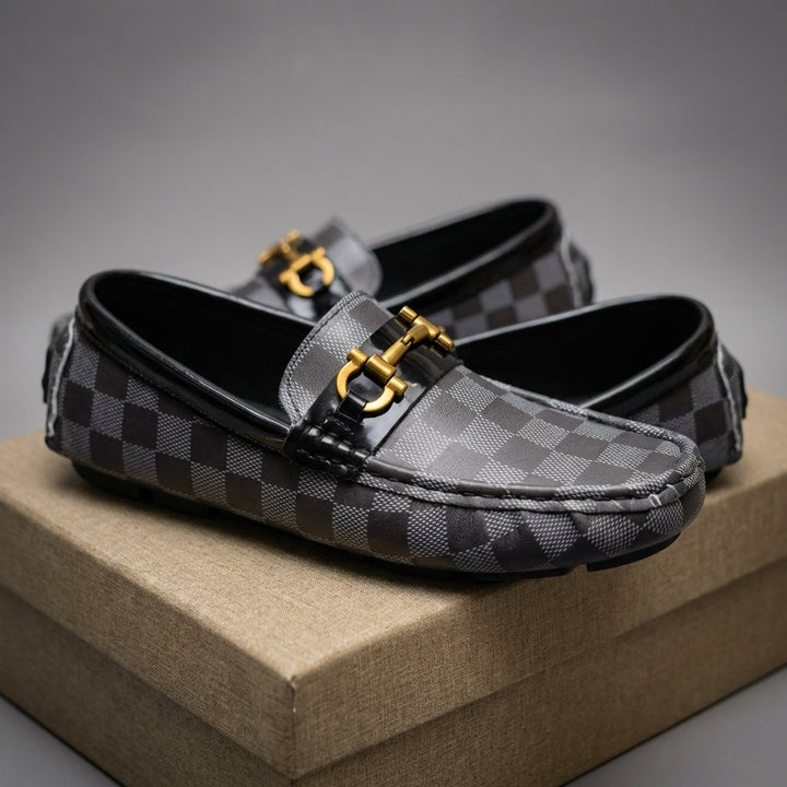 Close-up of men's slip-on loafers, highlighting checker pattern, soft material & everyday comfort.