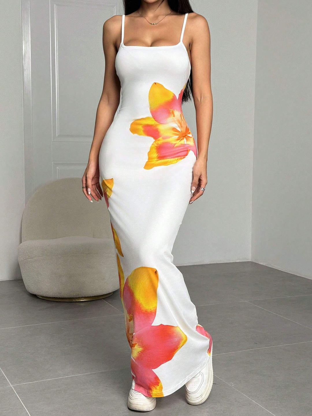 Women's elegant floral maxi dress with delicate spaghetti straps, perfect for summer vacations.