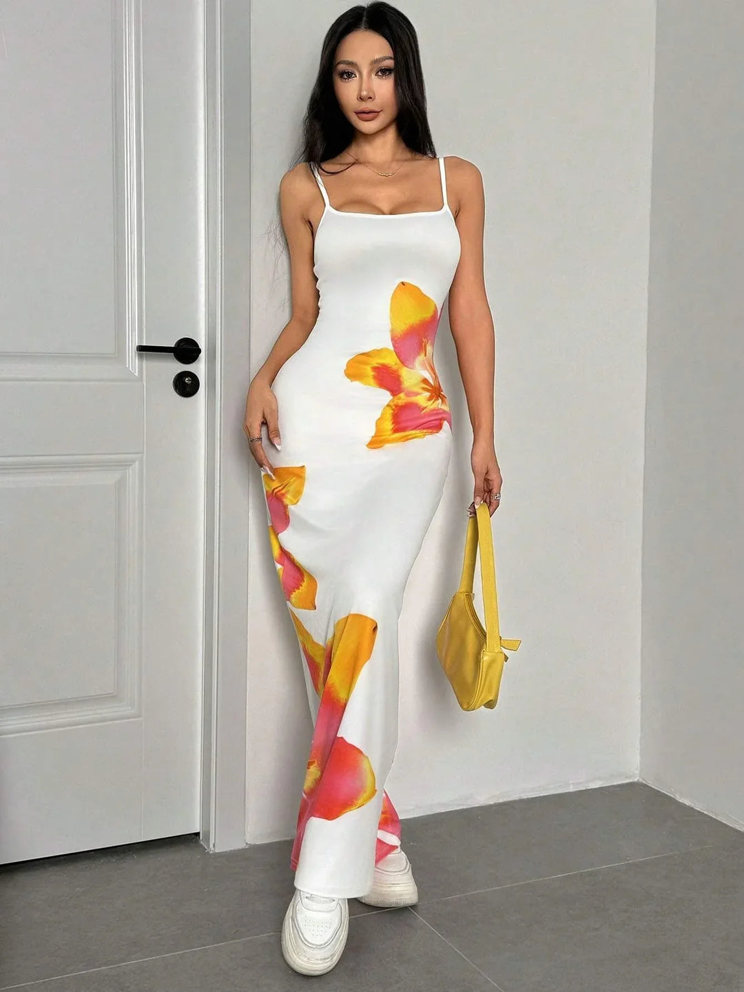 Stylish women's floral maxi dress with delicate spaghetti straps, suitable for summer events.