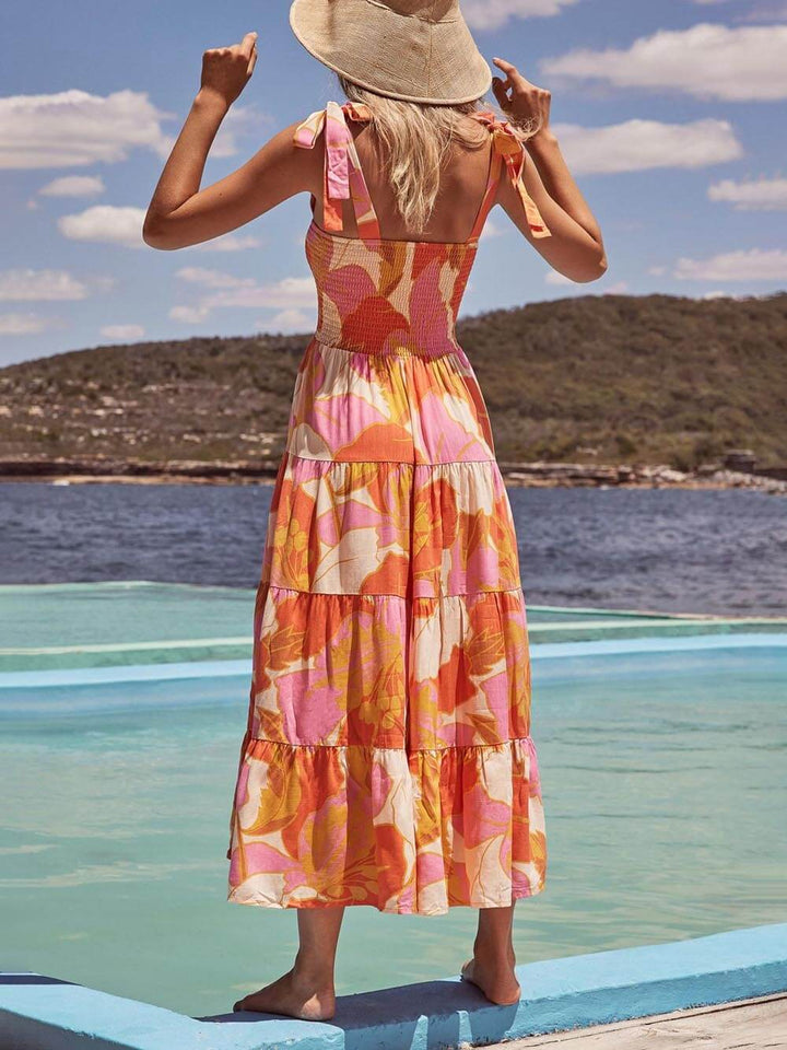 Comfortable women's sleeveless halter midi sundress with a bright multicolor pattern, perfect for warm weather.