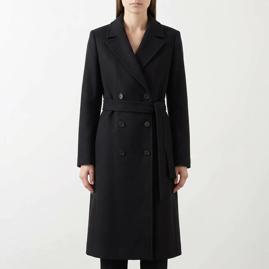 Women's elegant long coat with double-breasted front and belted waist, a classic winter fashion statement.