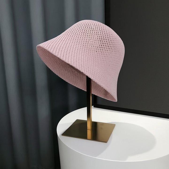Breathable hollow knit women's bucket hat for UV sun protection. Foldable, lightweight polyester, perfect travel & beach accessory.