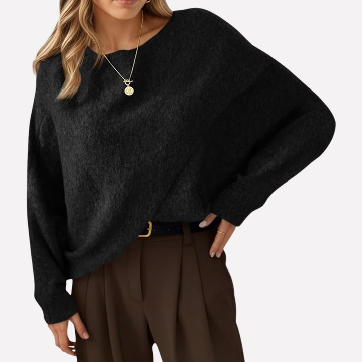 Women's casual batwing sweater with an oversized silhouette, crew neck, and trendy asymmetrical hem. Loose fit.