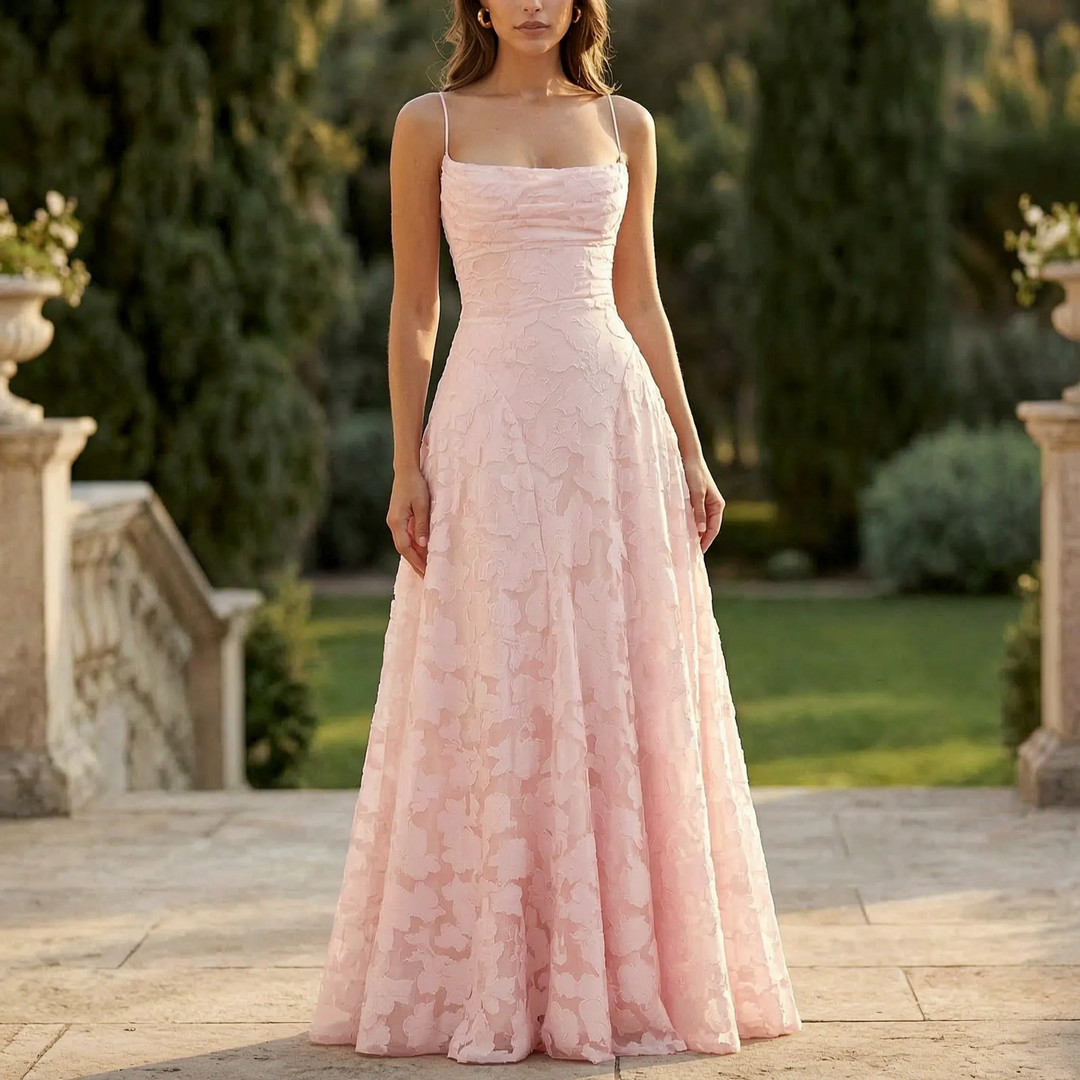Elegant women's floral textured maxi dress with thin spaghetti straps, perfect for evening events & special occasions.