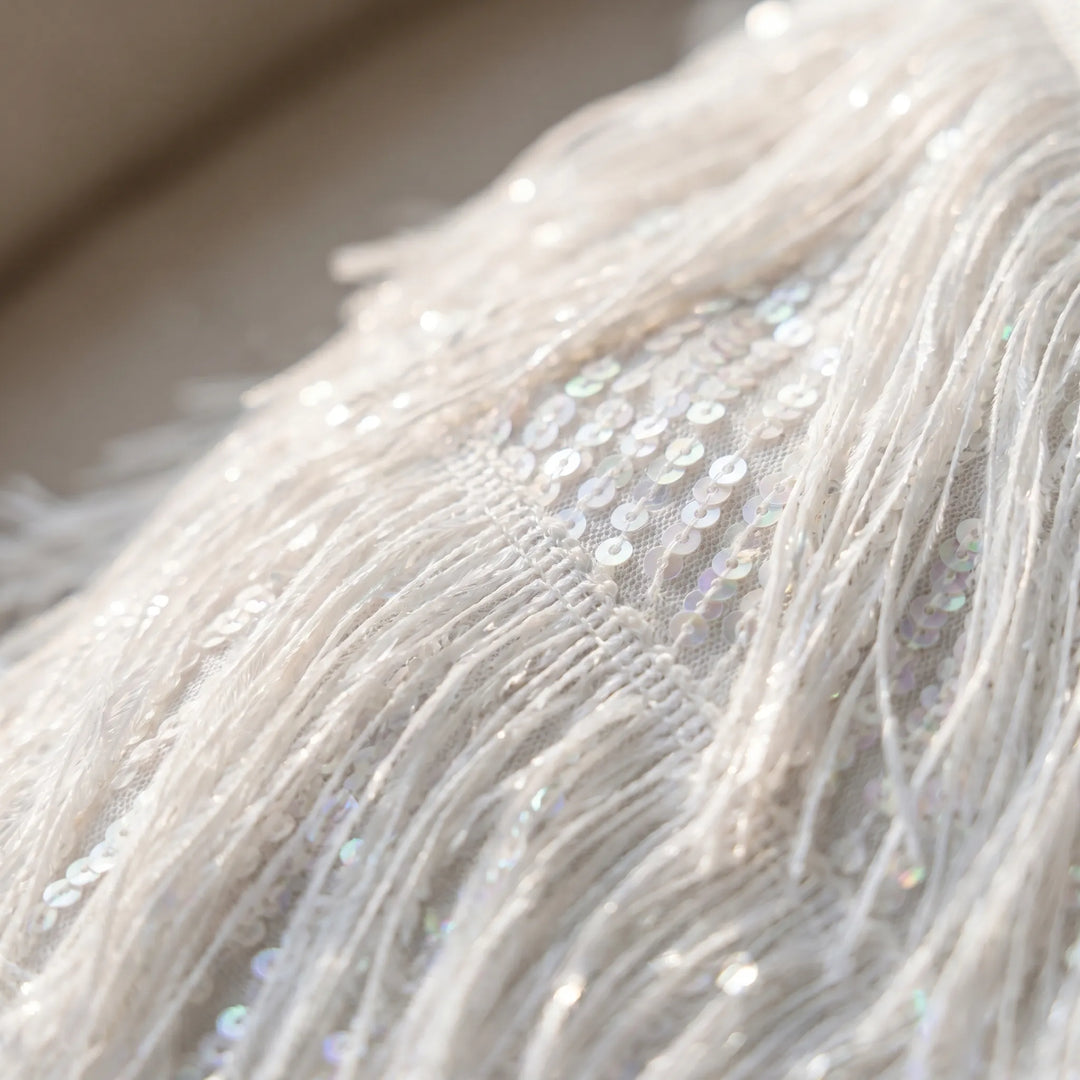 Dazzling women's shimmer mini dress with playful fringe detailing, a short, sleeveless design for evenings out.