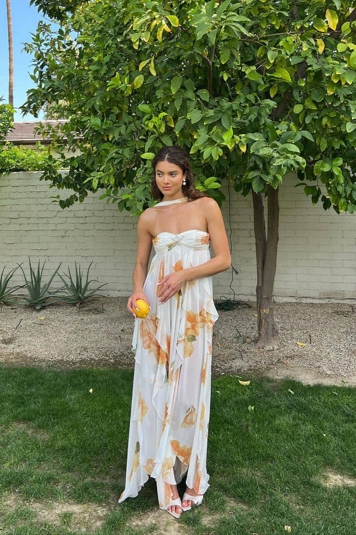 Elegant white halter maxi dress for women, perfect for summer occasions. Features a flowy silhouette and open back.