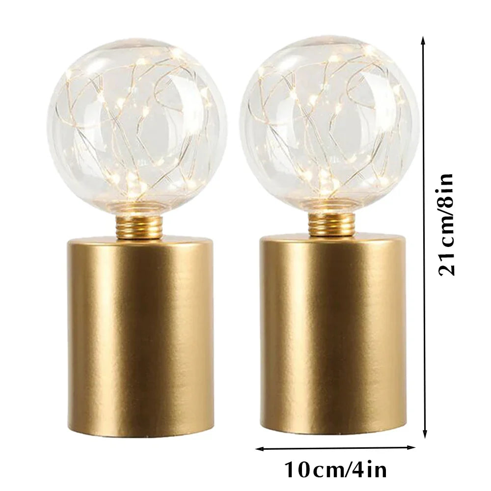 Modern gold cordless LED table lamps (2). Battery powered for easy placement, enhancing any contemporary home decor.
