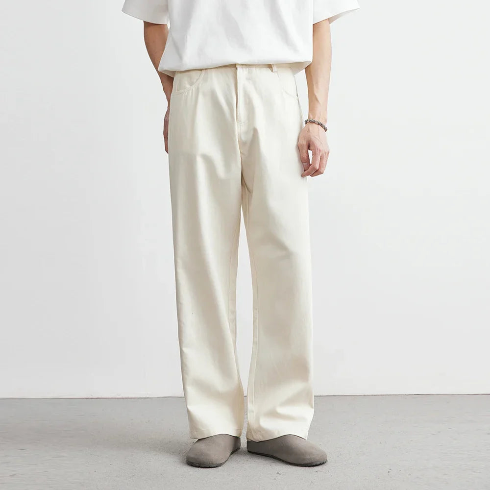 Apricot men's wide-leg utility pants with a relaxed fit. Modern, comfortable bottoms suitable for casual everyday style.