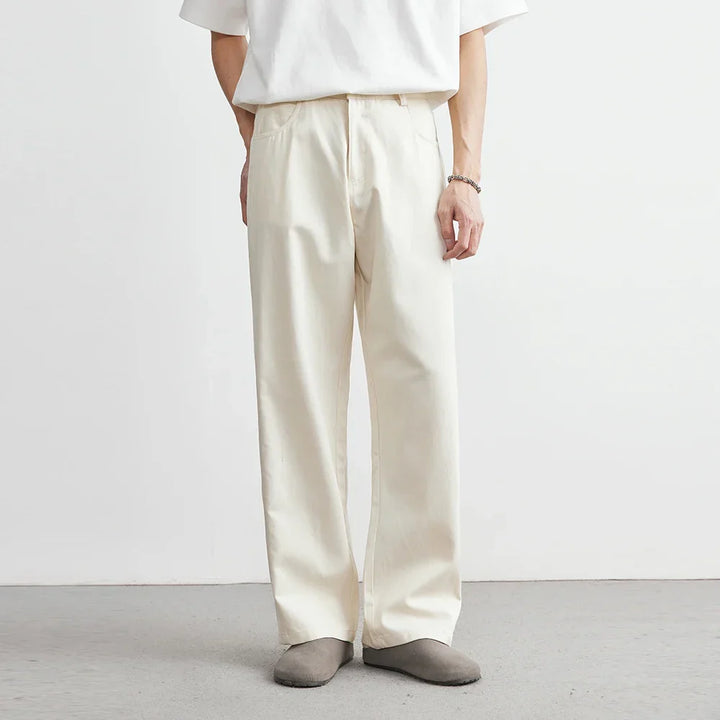 Apricot men's wide-leg utility pants with a relaxed fit. Modern, comfortable bottoms suitable for casual everyday style.