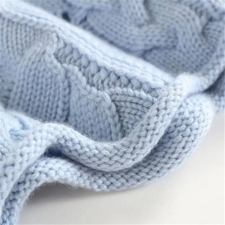 Elegant women's wavy cable knit turtleneck sweater, a warm blue knitwear piece for stylish fall & winter outfits.