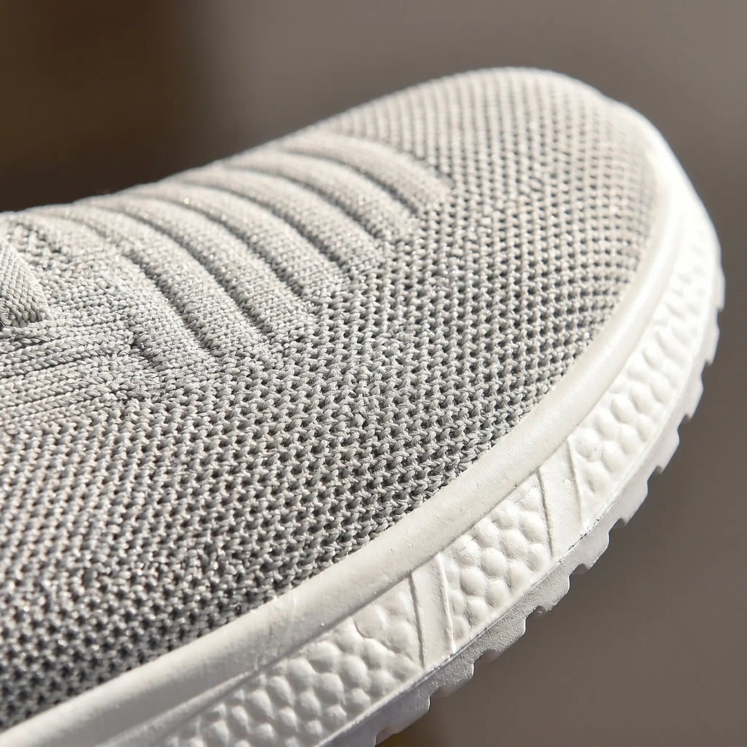 Women's comfort slip-on walking shoes with elastic laces & wide toe box. Offers orthopedic arch support.