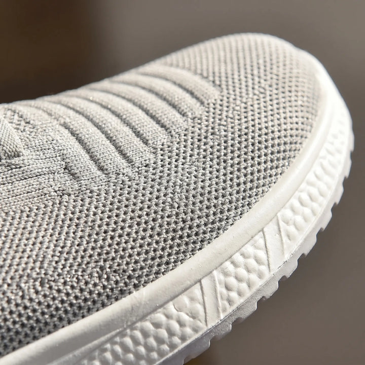 Women's comfort slip-on walking shoes with elastic laces & wide toe box. Offers orthopedic arch support.