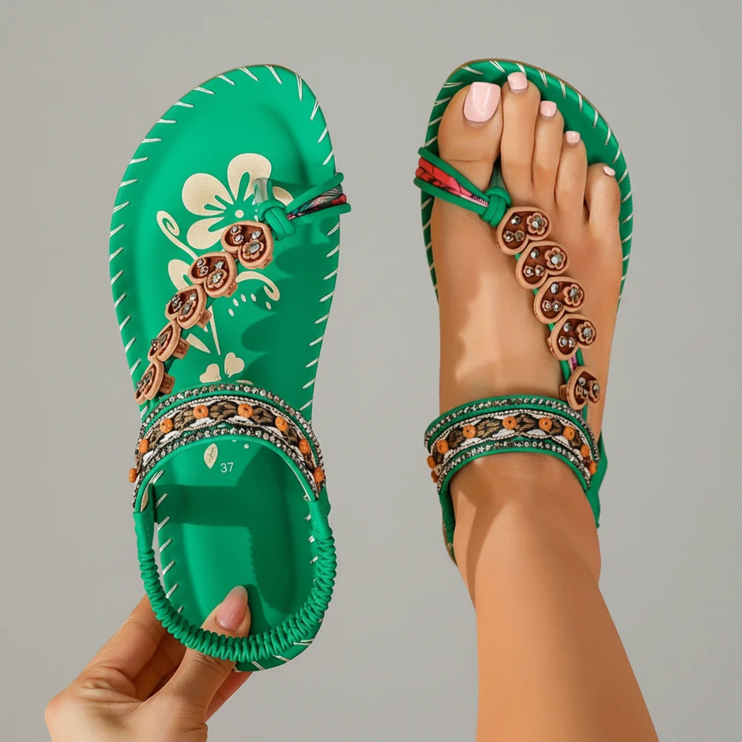 Comfortable women's bohemian thong sandals with a flat sole & secure ankle strap, perfect for all-day summer wear.