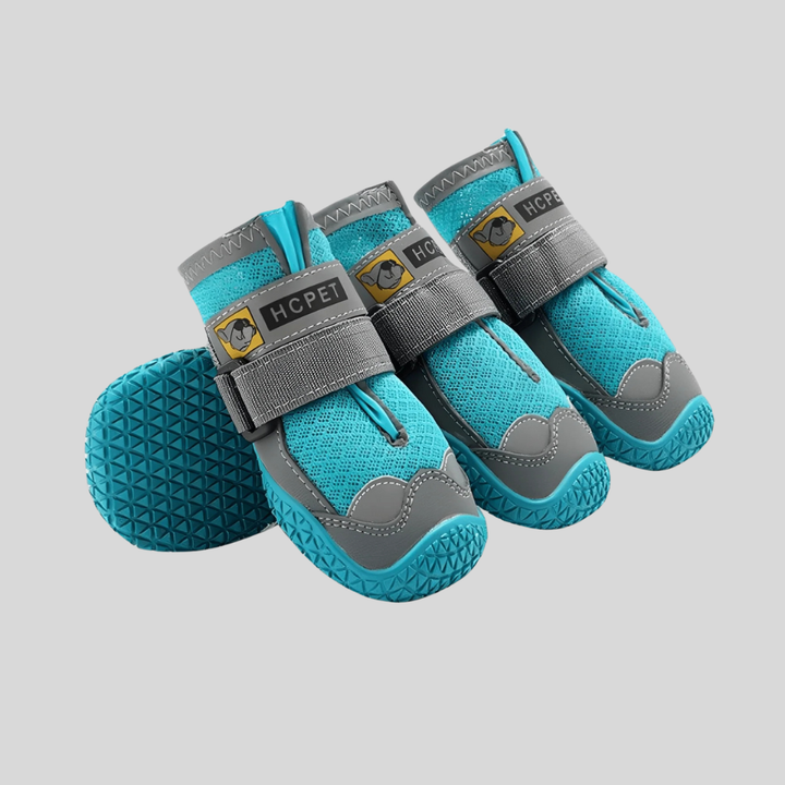 Black non-slip dog booties with secure straps, offering durable paw protection for active pet adventures.