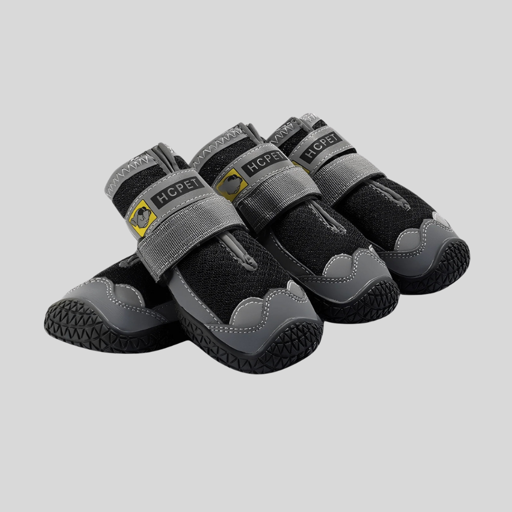 Pair of black protective non-slip dog shoes for all-weather paw protection, ideal for active dogs outdoors.