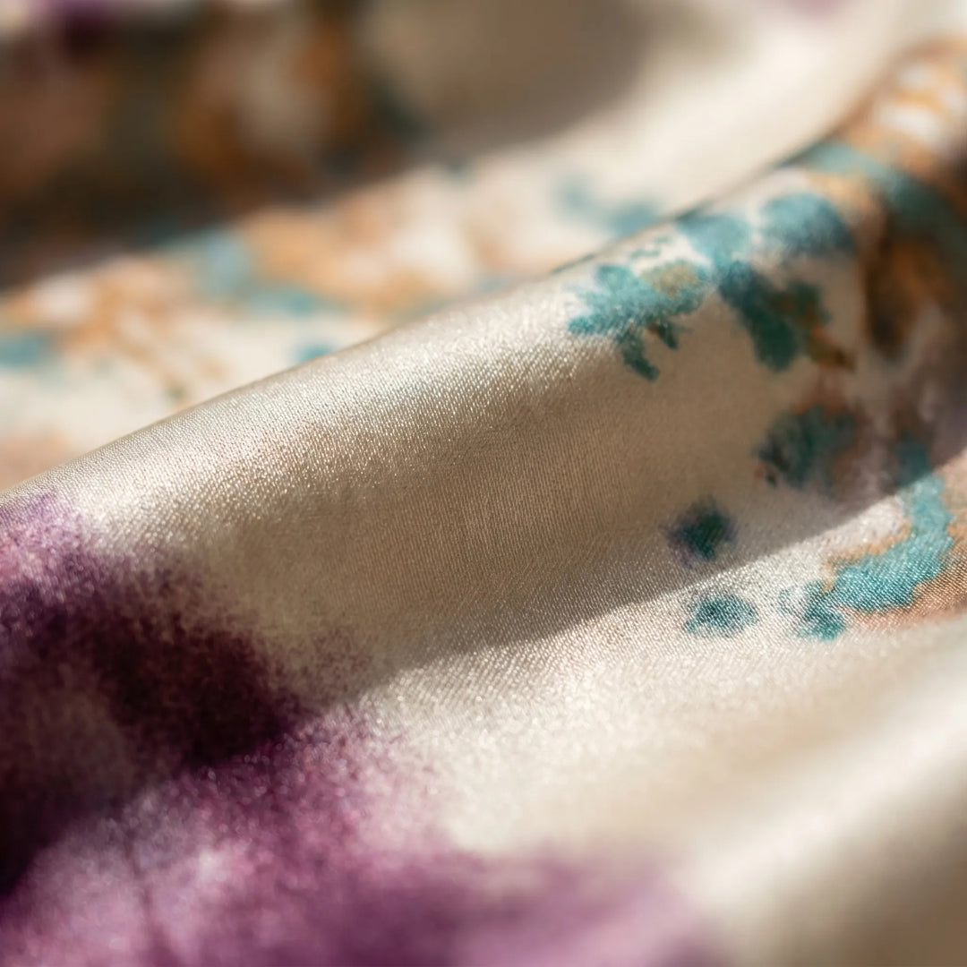 Elegant women's tie-dye wrap dress featuring an artistic print, V-neck, and flowy long sleeves, perfect for summer.