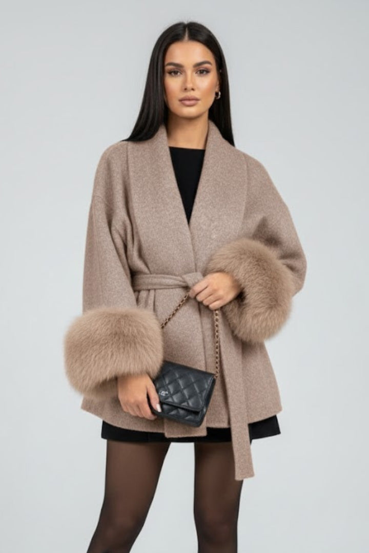 Warm full-length ladies winter coat. Stylish belted design with luxurious faux fur cuffs for elegant fashion.