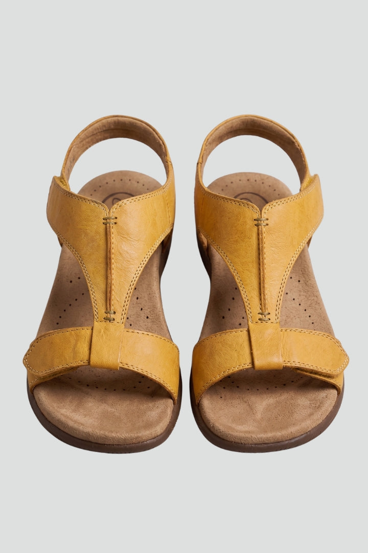 Women's flat T-strap sandals with cushioned footbed for ultimate comfort and summer style.
