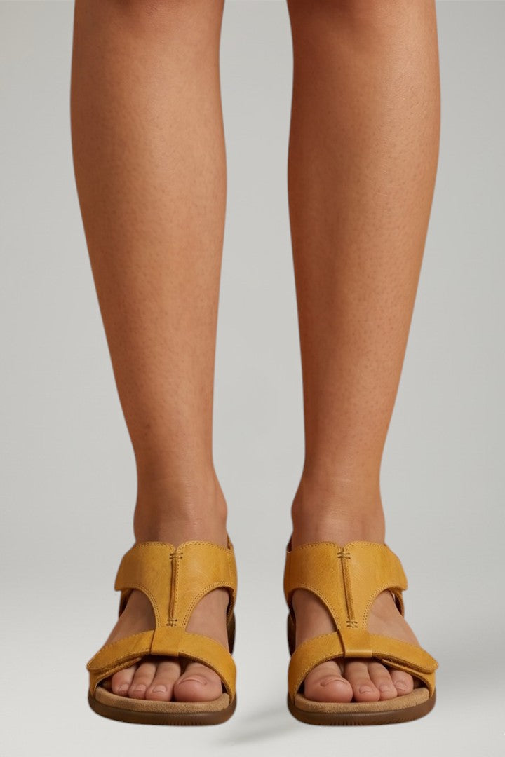 Comfortable women's flat sandals with adjustable T-strap and soft cushioned footbed.