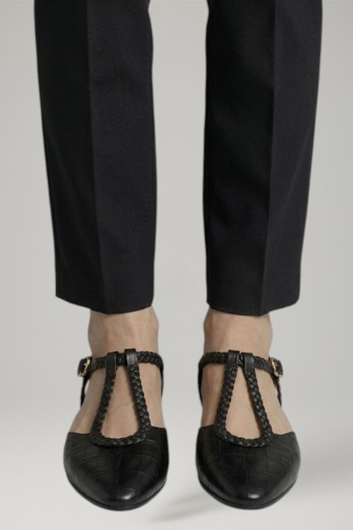Black T-strap women's flats with adjustable buckle, designed for elegant style and everyday comfortable wear.