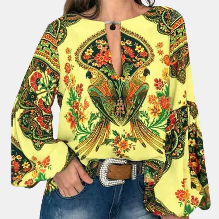 Lightweight cap sleeve women's blouse with vibrant floral print, ideal for summer fashion.