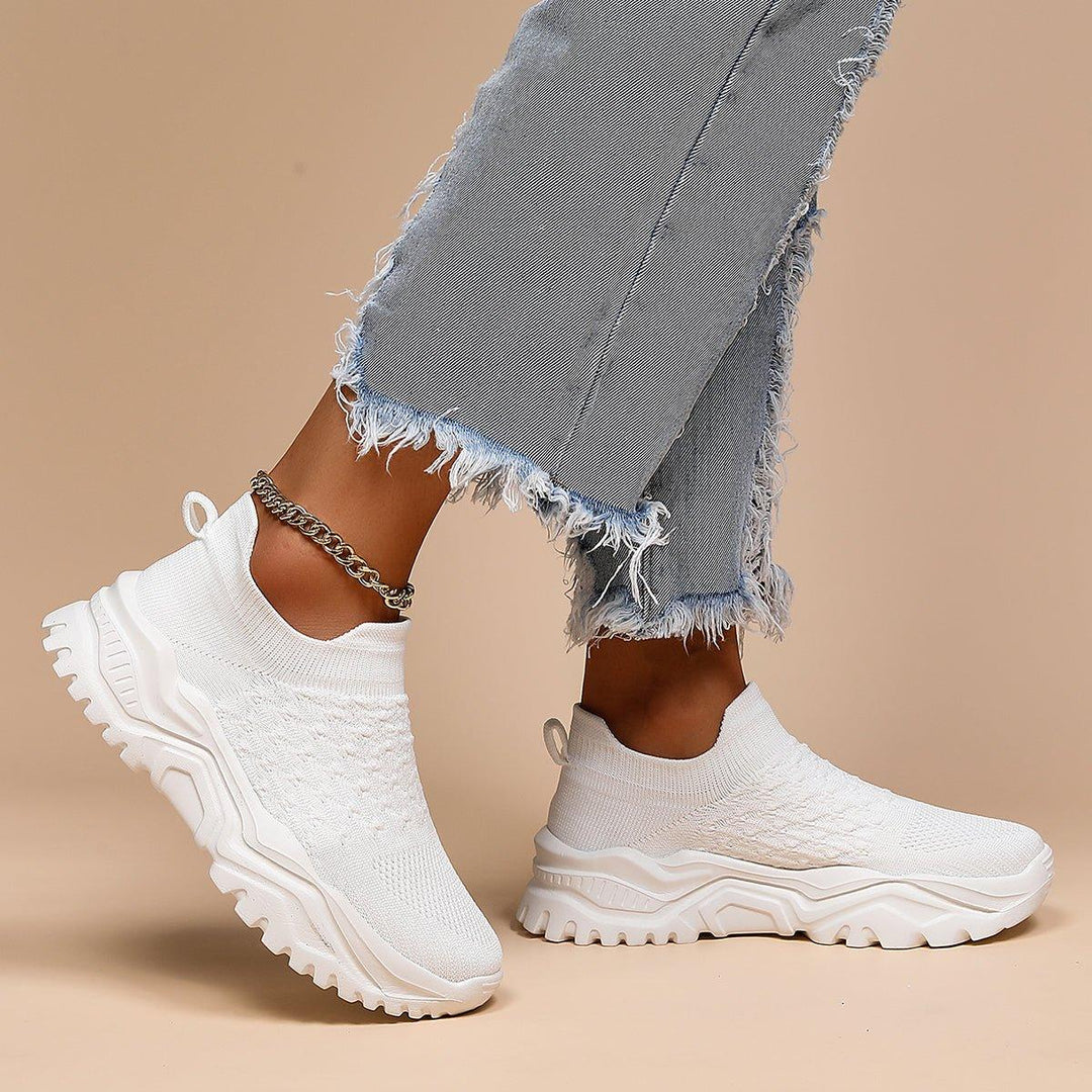 White orthopedic slip-on shoes, featuring a cushioned design and lightweight construction for superior comfort.
