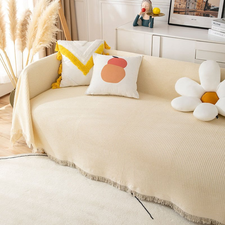 Soft beige stretch sofa slipcover, pet-friendly furniture protector for living room decor & easy cleaning.