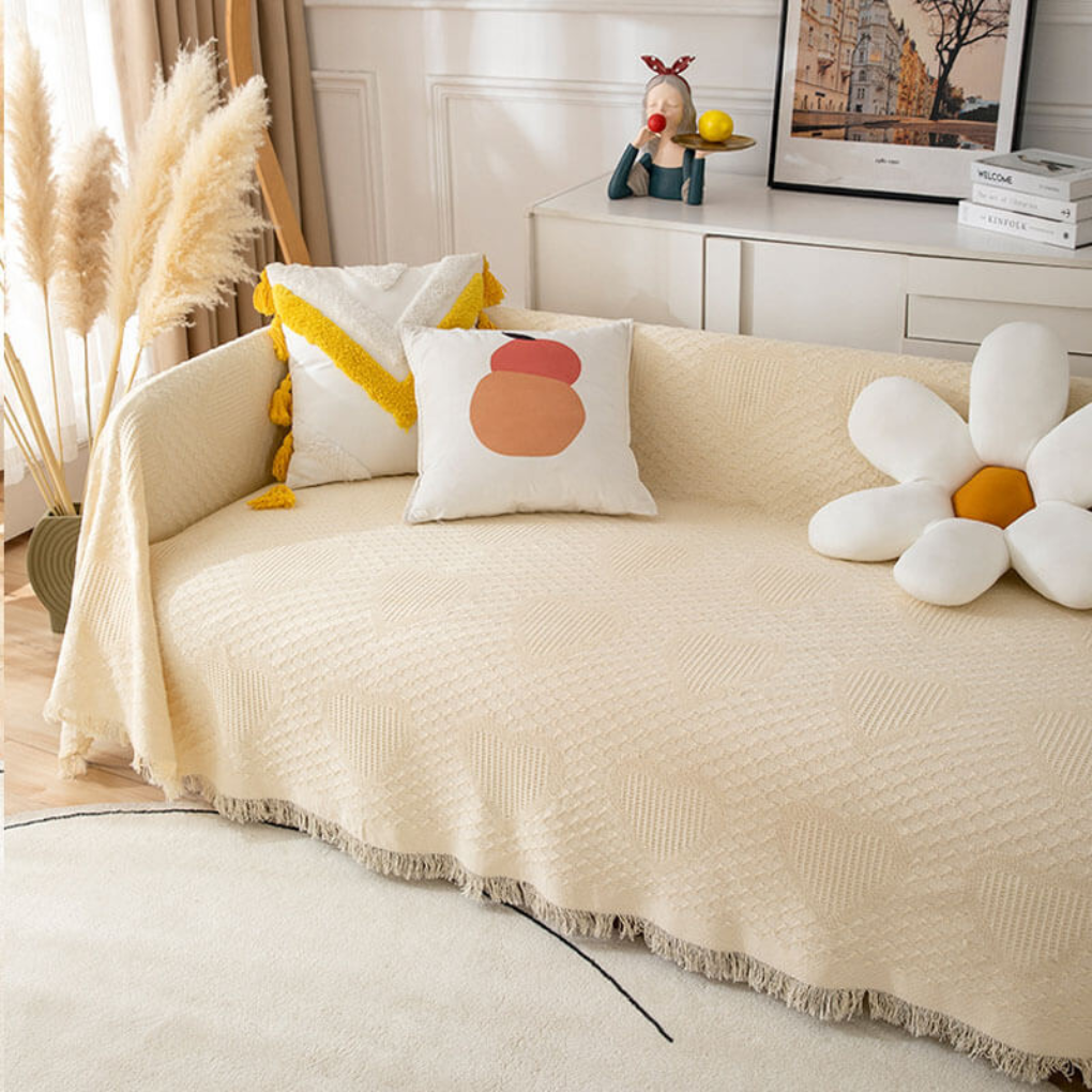 Beige & white stretchable pet-friendly sofa cover, a soft slipcover for living room furniture protection.