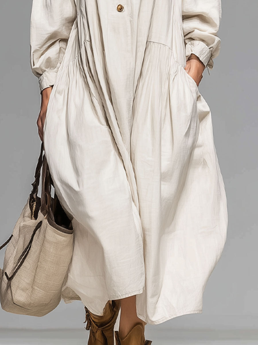 Stylish women's beige midi dress featuring a loose fit, long sleeves, and practical button-front with pockets.