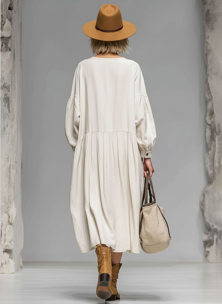 Elegant loose-fit beige midi dress for women with long sleeves, button front & pockets. Ideal for fall fashion.