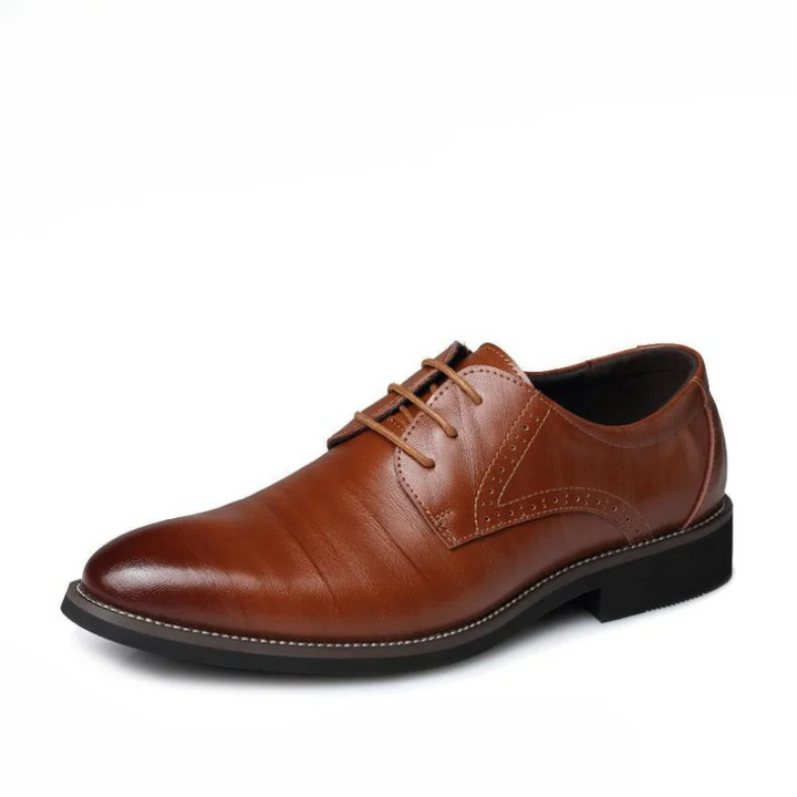 Close-up of sole texture and fine leather on men's black classic lace-up Oxford dress shoes. Formal footwear detail.