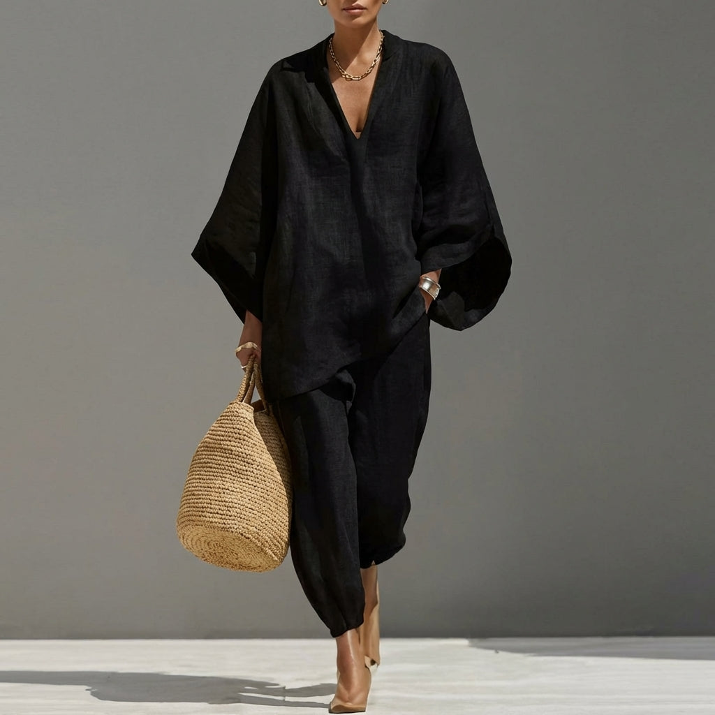 Beige women's two-piece outfit: relaxed tunic top & tapered pants. Chic, comfortable, perfect for casual wear or travel.