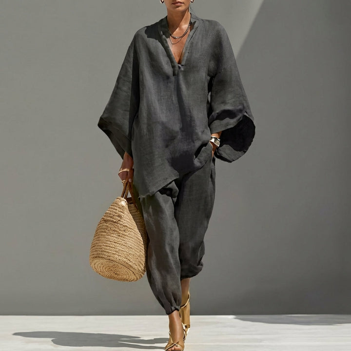 Detail of black women's relaxed tunic top & tapered pants set. Soft fabric, comfortable fit, casual elegance, travel ready.