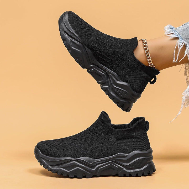 Unisex black slip-on shoes with advanced orthopedic cushioning, ideal for all-day wear.