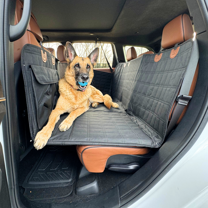 Black waterproof dog backseat extender & car seat protector with door covers for safe pet travel.