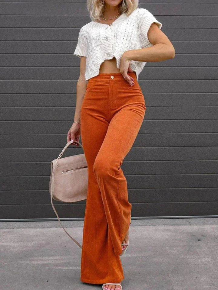 Dark blue women's flare pants, high-waisted with functional pockets for work & casual wear.