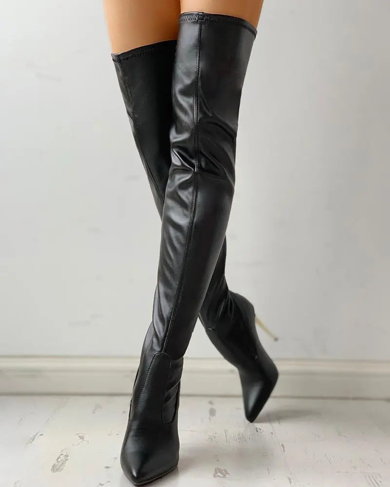 Black women's knee-high zip-up boots with low heel, perfect for elegant formal or casual versatile wear.