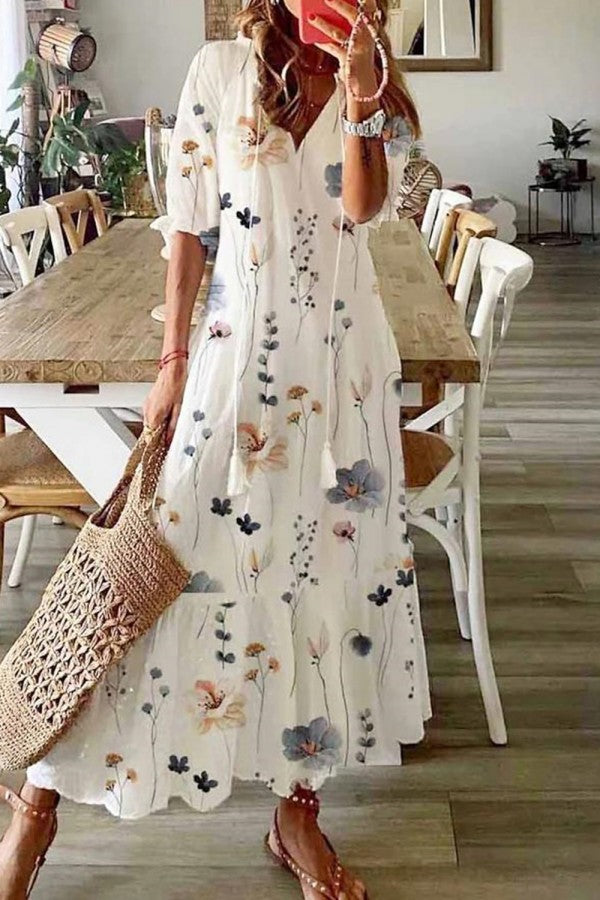 Bohemian floral print V-neck maxi dress for women, with elegant tassels & a flowy silhouette, perfect for summer.