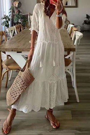 Stylish women's summer maxi dress with a V-neck, tassel detail, and a beautiful floral print, great for resort wear.