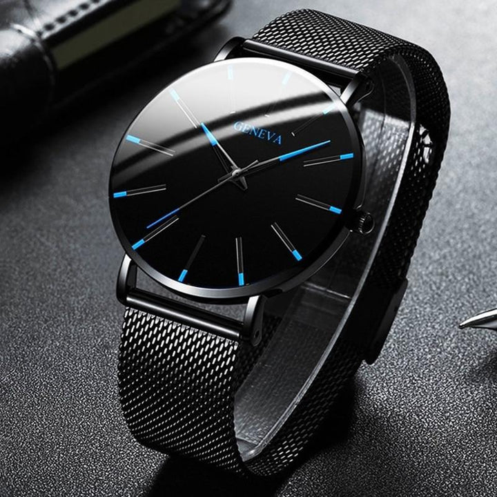 Sophisticated men's timepiece worn on a wrist, featuring a black strap and striking blue accent details.