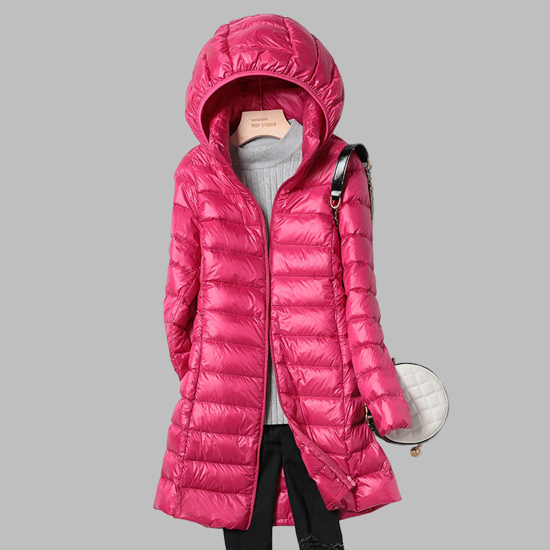 Women's long hooded puffer jacket, offering stylish protection & ultimate warmth against winter cold.