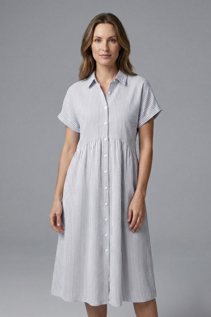 Stylish women's spring midi dress, collared with full button closure. Versatile for day-to-night wear.