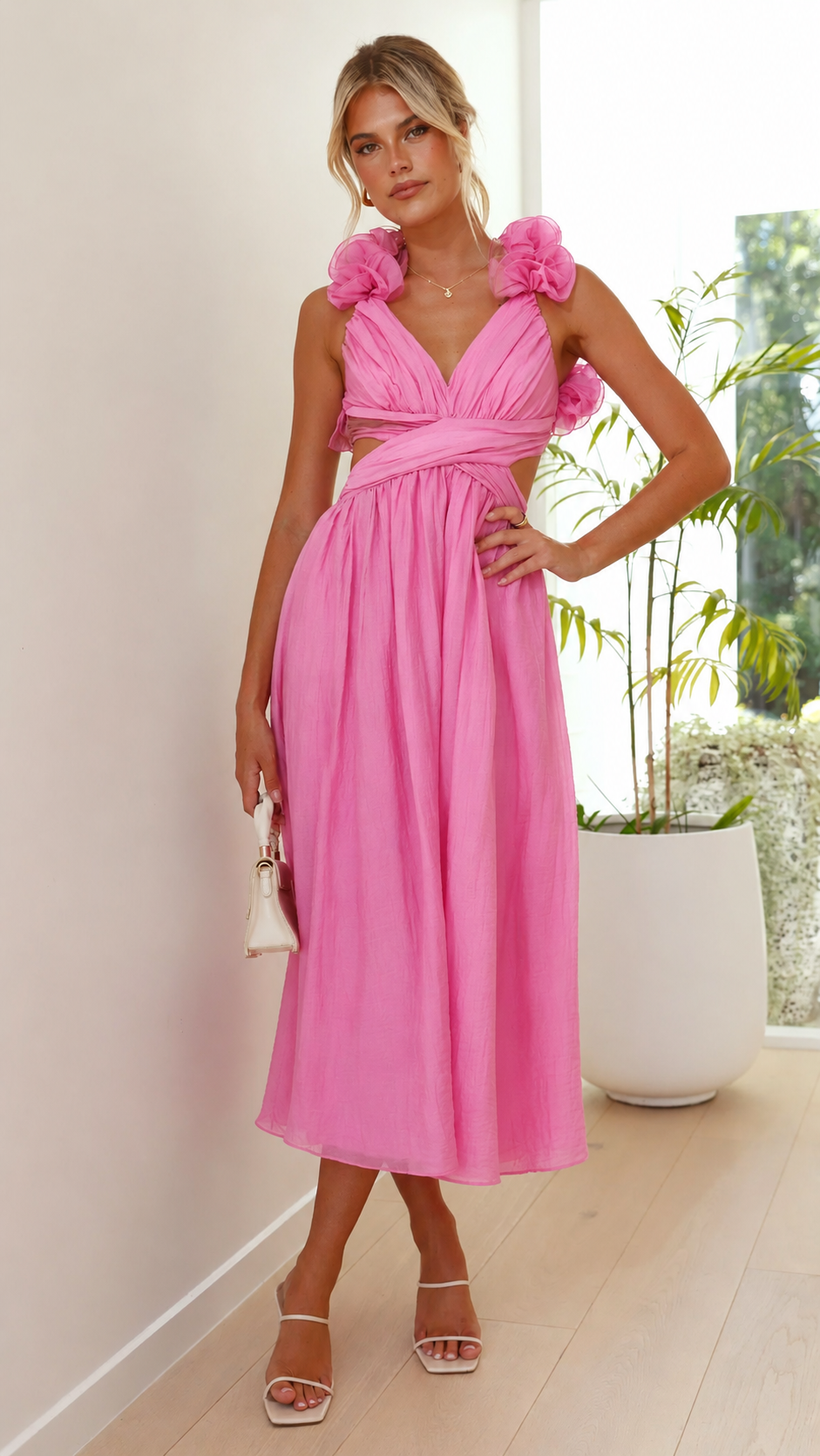 Flowy pink maxi wedding guest dress with ruffles & a flattering lace-up back for elegant style.
