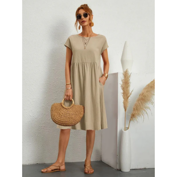 Elegant women's cap sleeve midi dress, A-line cut, round neck, with practical pockets for everyday.