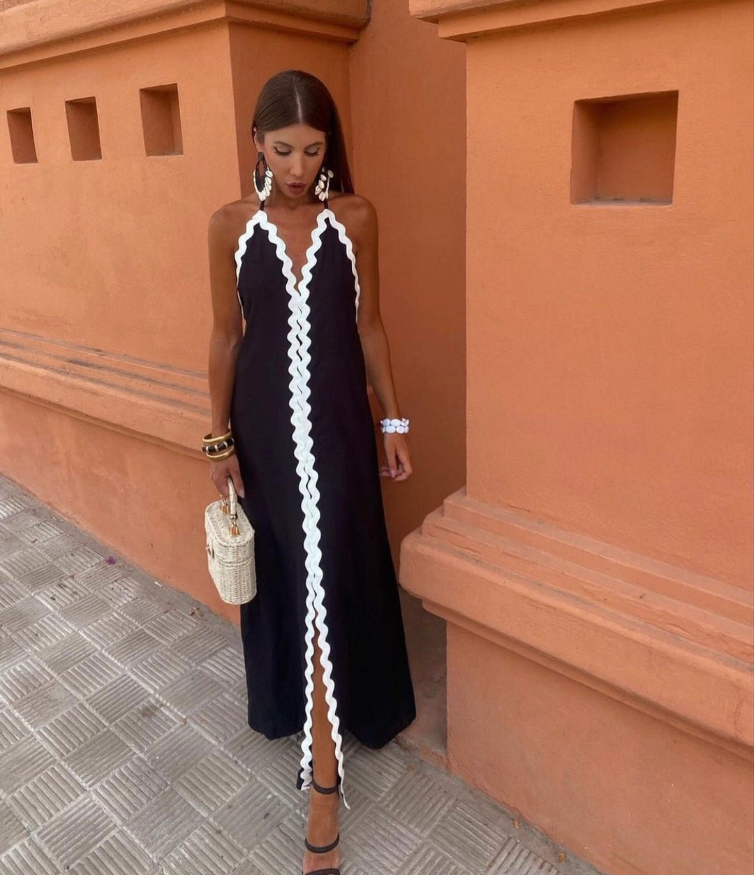 Chic women's black and white contrast trim maxi wedding guest dress, elegant V-neck sleeveless formal wear.