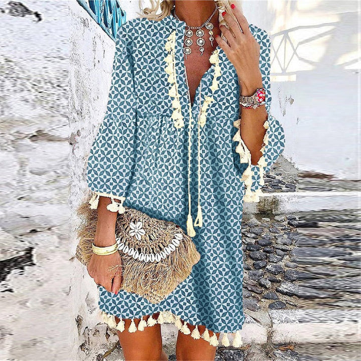 Chic women's boho mini dress with V-neck, bell sleeves & tassels. Perfect for summer casual or bohemian style.