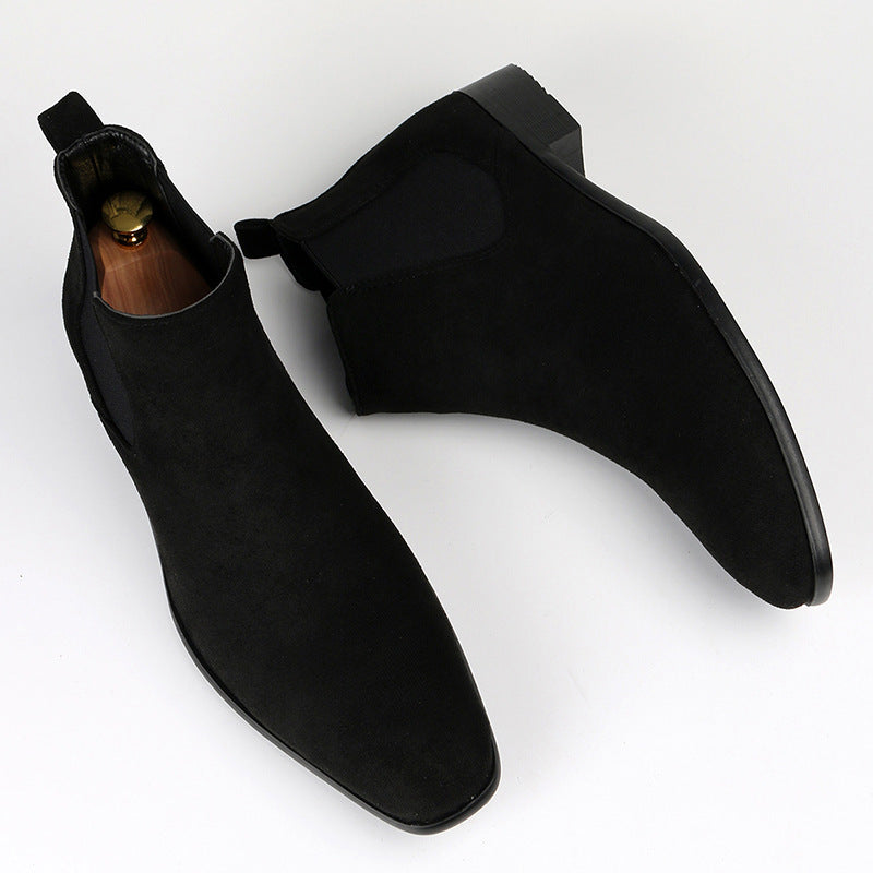 Women's black Chelsea ankle boots with a sturdy block heel, offering slip-on convenience for versatile wear.