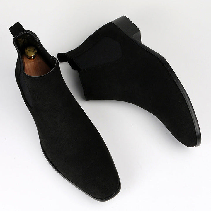 Women's black Chelsea ankle boots with a sturdy block heel, offering slip-on convenience for versatile wear.