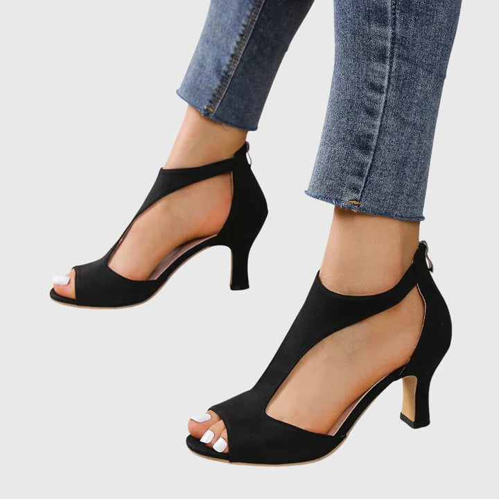 Stylish women's block heel sandals with a peep toe, cut out details, and an ankle zip for comfortable chic footwear.