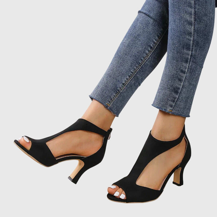 Modern women's cut out peep toe block heel sandals with secure ankle zip, offering both style and comfort.